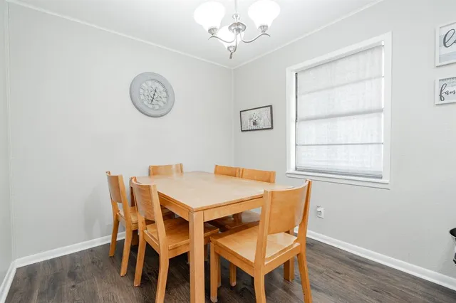 a dining room with a wooden table and a window