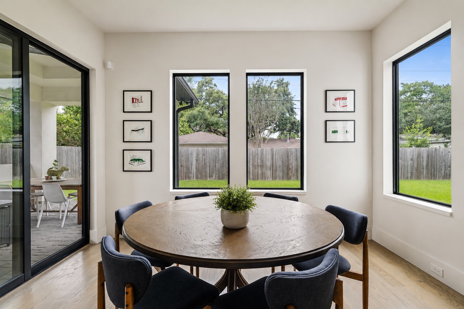 4638 Merwin Street Houston, TX 77027 - Photo 12 of 42 The breakfast room is surrounded by large windows.