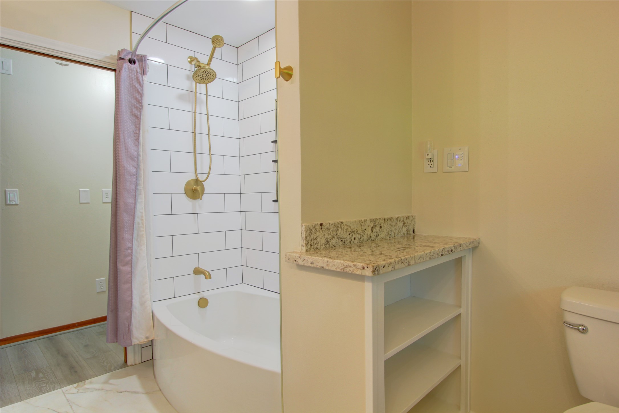 1904 Pine Street Liberty, TX 77575 - Photo 17 of 33 a bathroom with a granite countertop bathtub and toilet