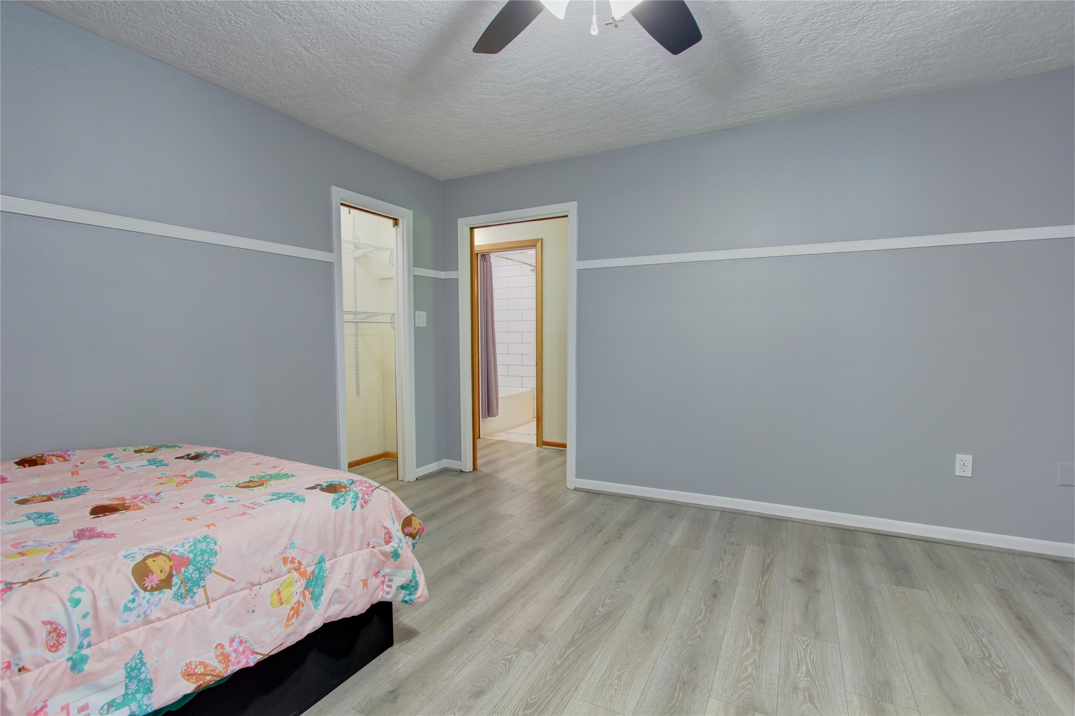 1904 Pine Street Liberty, TX 77575 - Photo 21 of 33 a bedroom with a bed and a chandelier