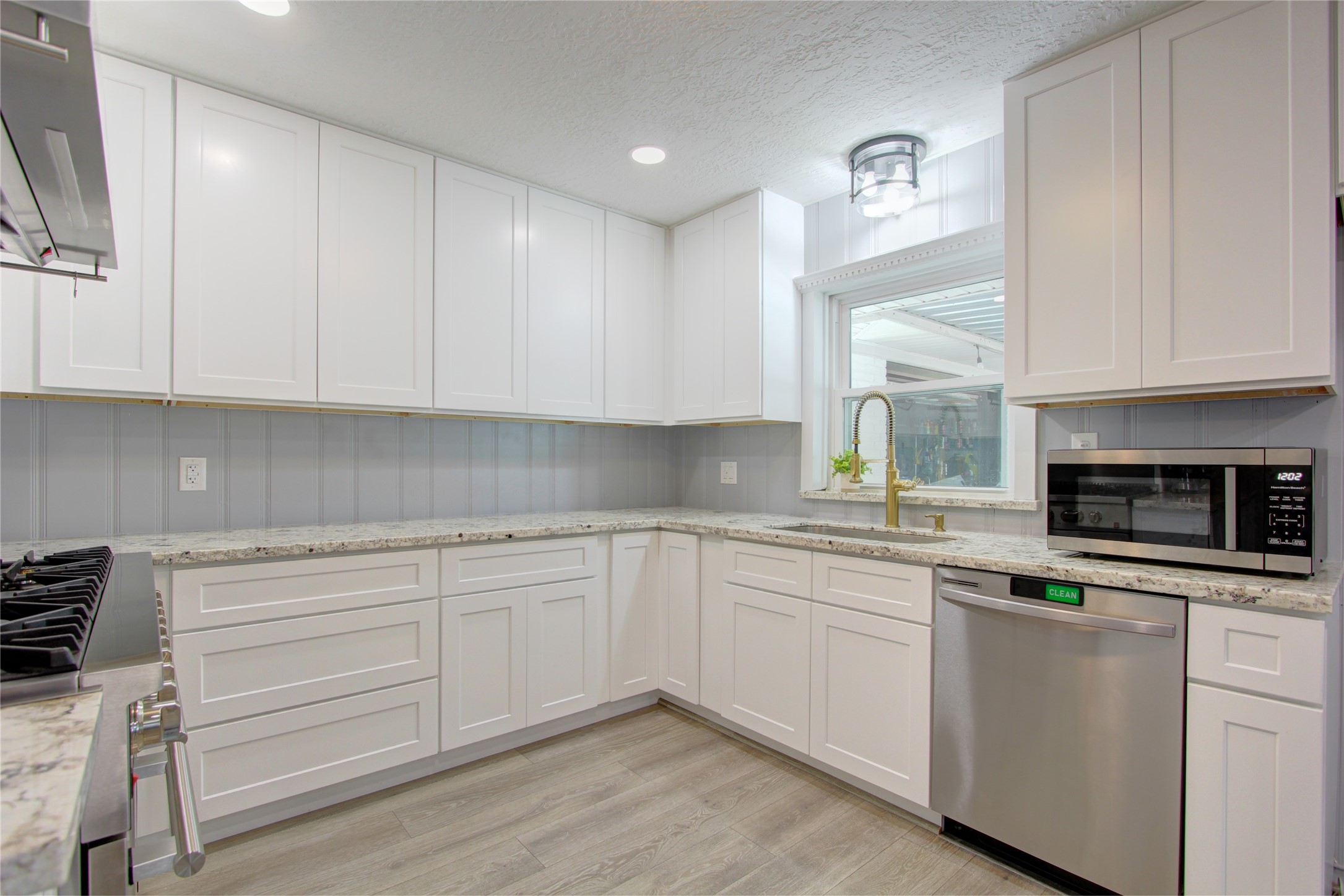 1904 Pine Street Liberty, TX 77575 - Photo 9 of 33 a kitchen with cabinets appliances a sink and a window