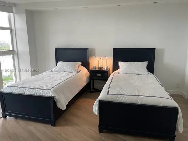 a bedroom with bed and window