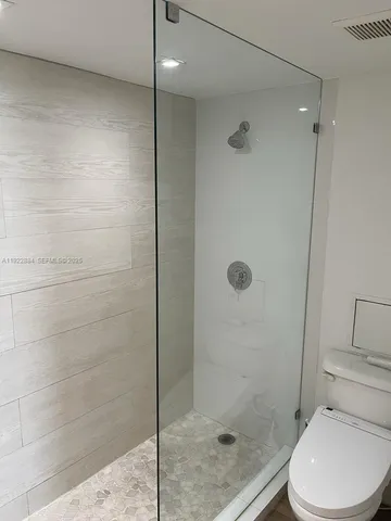 a bathroom with a shower and toilet