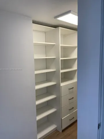 a view of walk in closet with empty racks