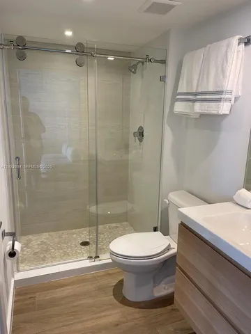 a bathroom with a toilet and a shower