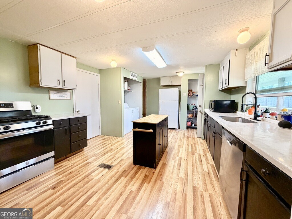 94 Country Place Temple, GA 30179 - Photo 24 of 36 a large kitchen with stainless steel appliances granite countertop a lot of counter space and wooden floor