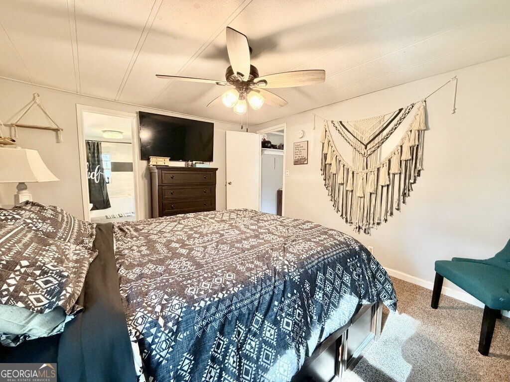 94 Country Place Temple, GA 30179 - Photo 26 of 36 a bedroom with a bed and a flat screen tv