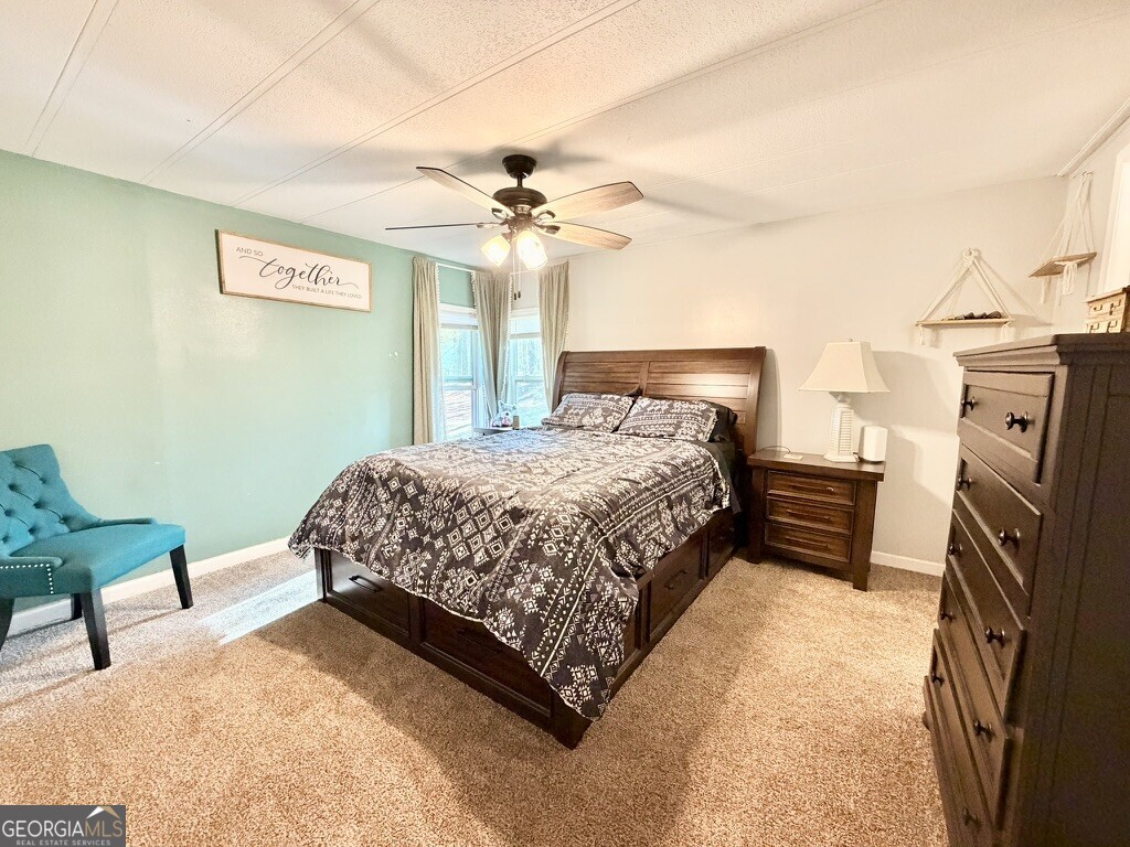 94 Country Place Temple, GA 30179 - Photo 27 of 36 a bedroom with a bed and a chandelier