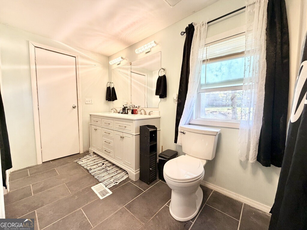 94 Country Place Temple, GA 30179 - Photo 29 of 36 a bathroom with a toilet sink and a mirror