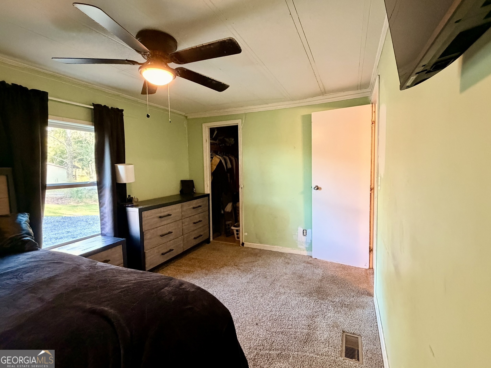 94 Country Place Temple, GA 30179 - Photo 36 of 36 a bedroom with a bed and a flat tv screen on dresser