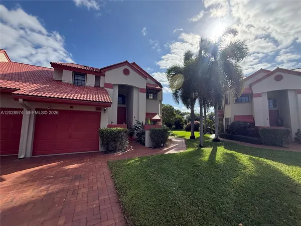 a view of a house with a yard patio and a fountain