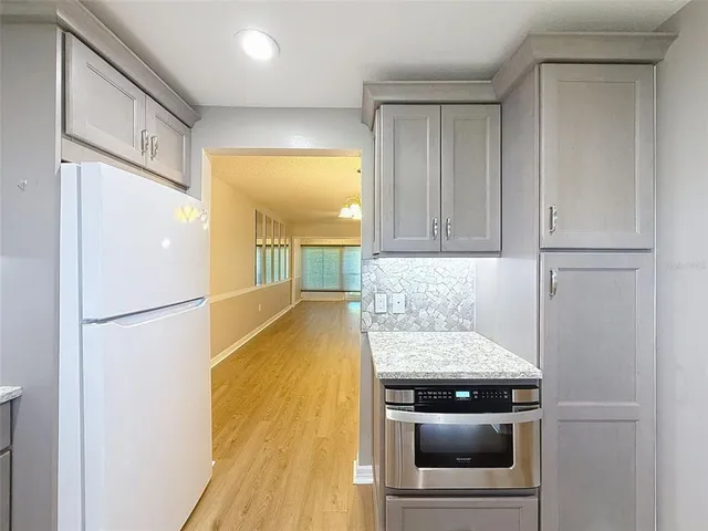a kitchen with a refrigerator and cabinets
