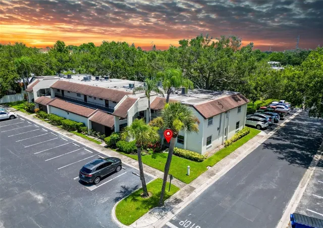 a view of a patio with furniture and a garden