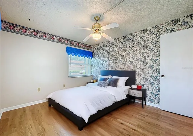 a bedroom with a bed and a chandelier