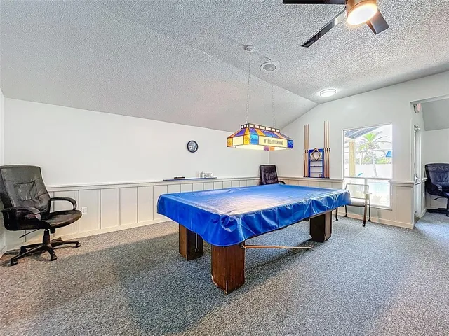 a living room with furniture a air conditioner vent and a window