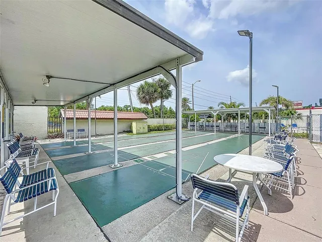 a view of a patio with a table chairs and backyard