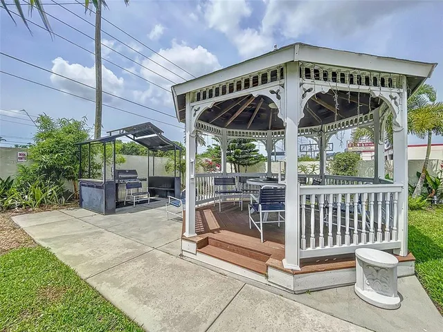 a view of patio with a table and chairs under an umbrella