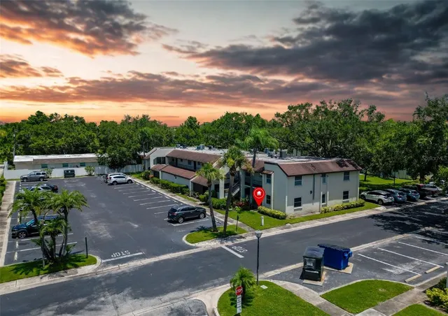 an aerial view of city lake and trees
