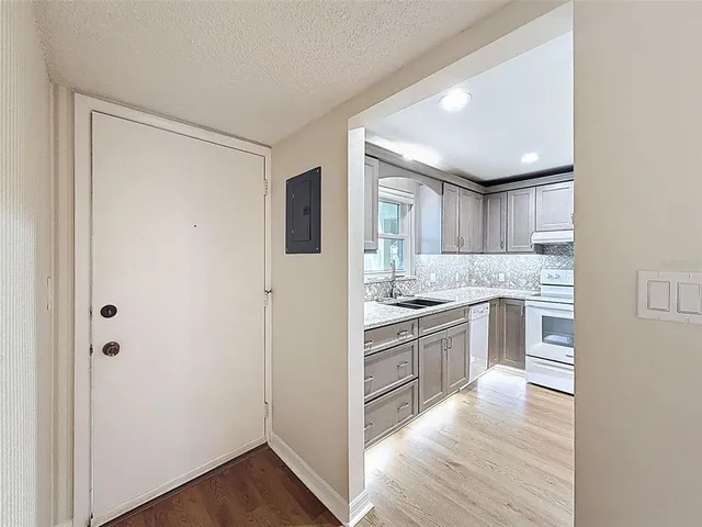 a kitchen with cabinets and wooden floor