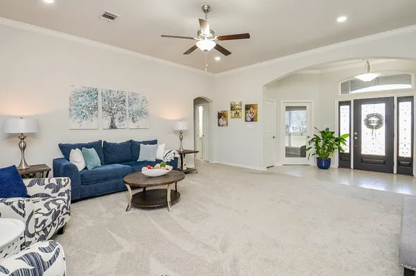 a living room with furniture wooden floor and a large window