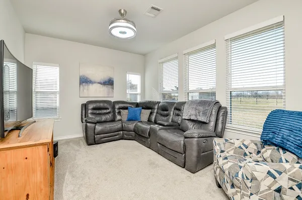 a large kitchen with a table and chairs
