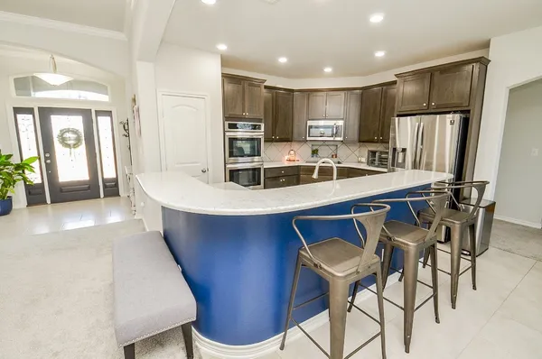 a kitchen with a sink stainless steel appliances and cabinets