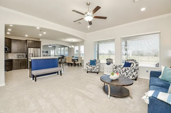 a living room with furniture and a chandelier