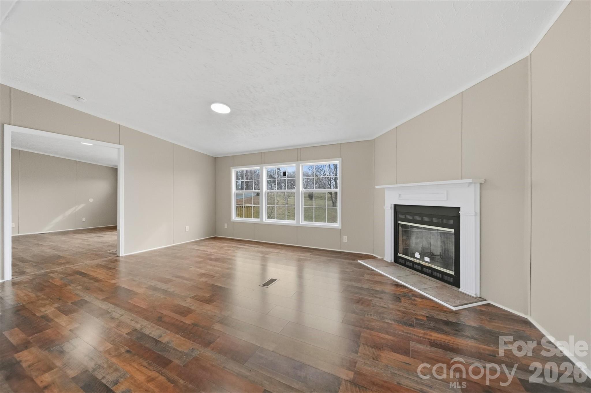 3150 Cranberry Road Boonville, NC 27011 - Photo 11 of 45 a view of an empty room with a fireplace and a window