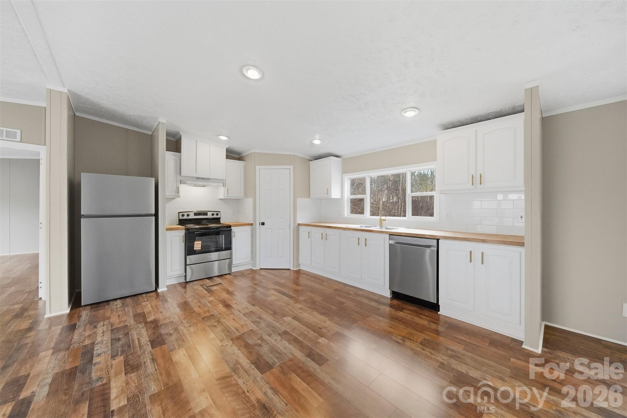 3150 Cranberry Road Boonville, NC 27011 - Photo 14 of 45 a kitchen with white cabinets and stainless steel appliances