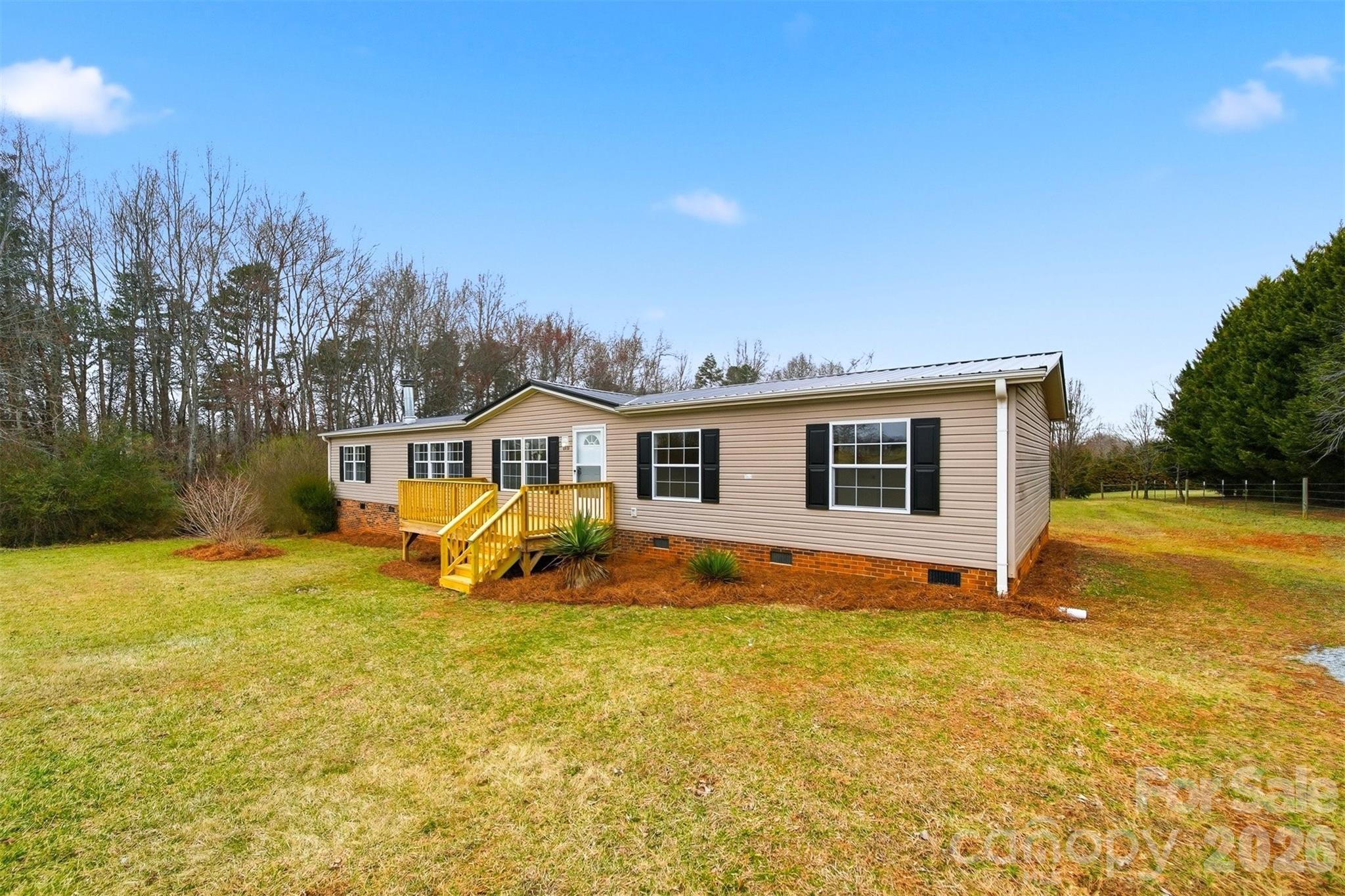 3150 Cranberry Road Boonville, NC 27011 - Photo 2 of 45 a view of a house with backyard outdoor seating and covered with trees