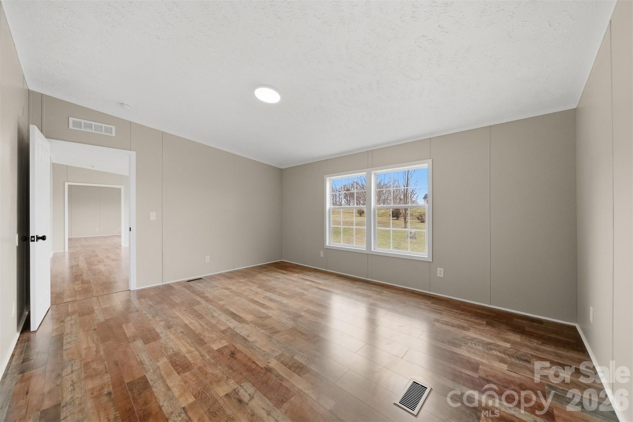 3150 Cranberry Road Boonville, NC 27011 - Photo 22 of 45 a view of an empty room with wooden floor and a window