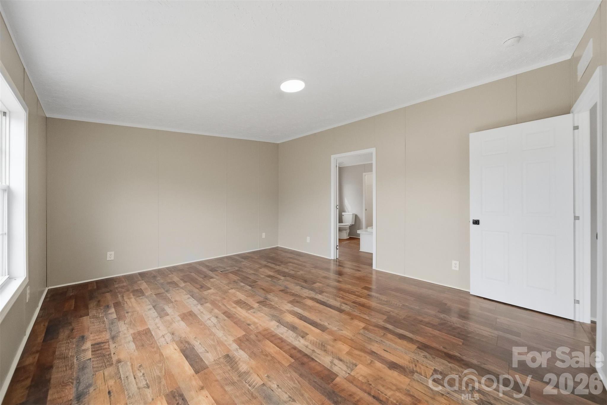 3150 Cranberry Road Boonville, NC 27011 - Photo 23 of 45 a view of empty room with wooden floor and fan