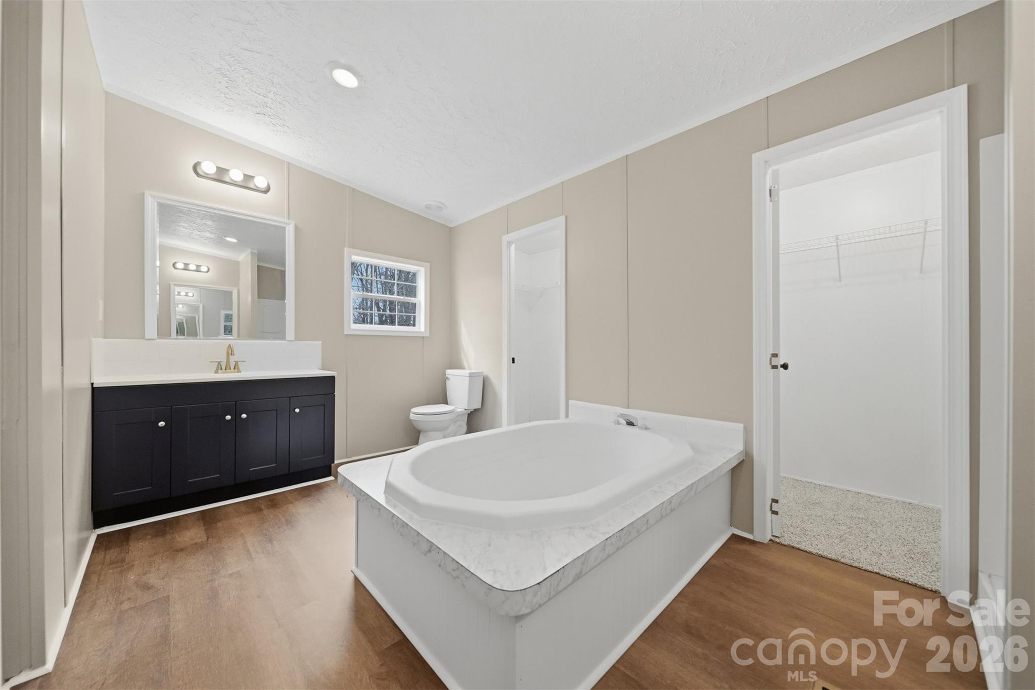 3150 Cranberry Road Boonville, NC 27011 - Photo 24 of 45 a spacious bathroom with a tub sink and mirror
