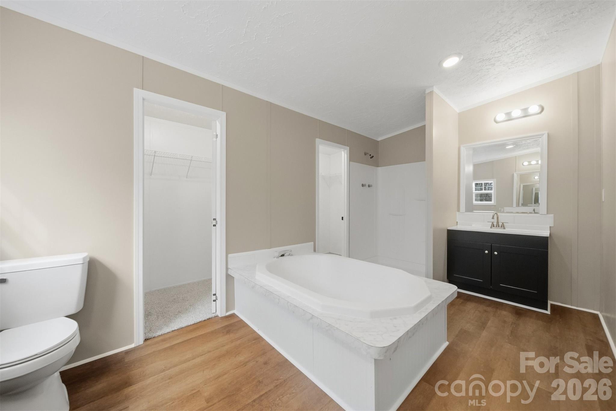 3150 Cranberry Road Boonville, NC 27011 - Photo 25 of 45 a bathroom with a sink a toilet and mirror