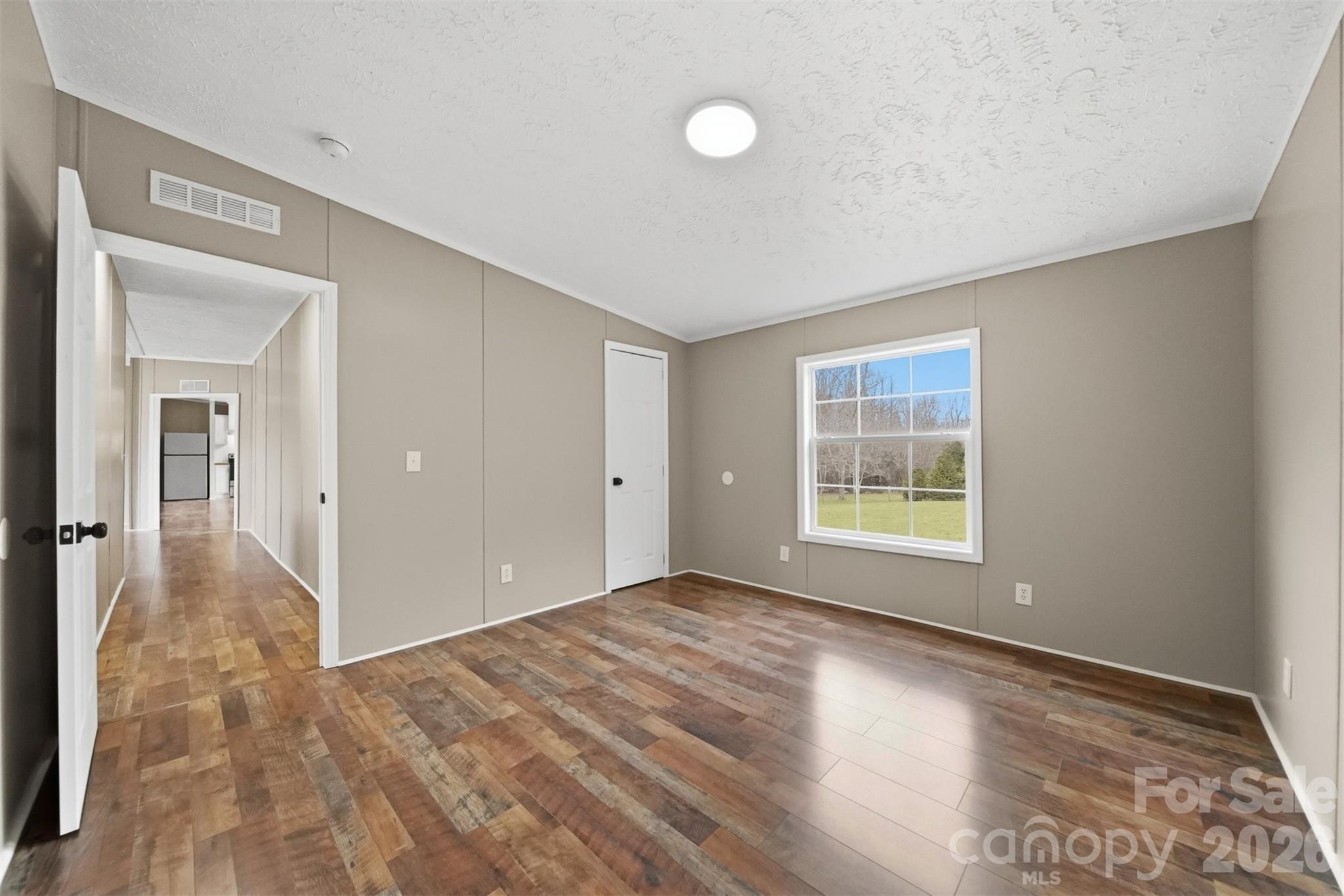 3150 Cranberry Road Boonville, NC 27011 - Photo 29 of 45 a view of empty room with wooden floor and fan