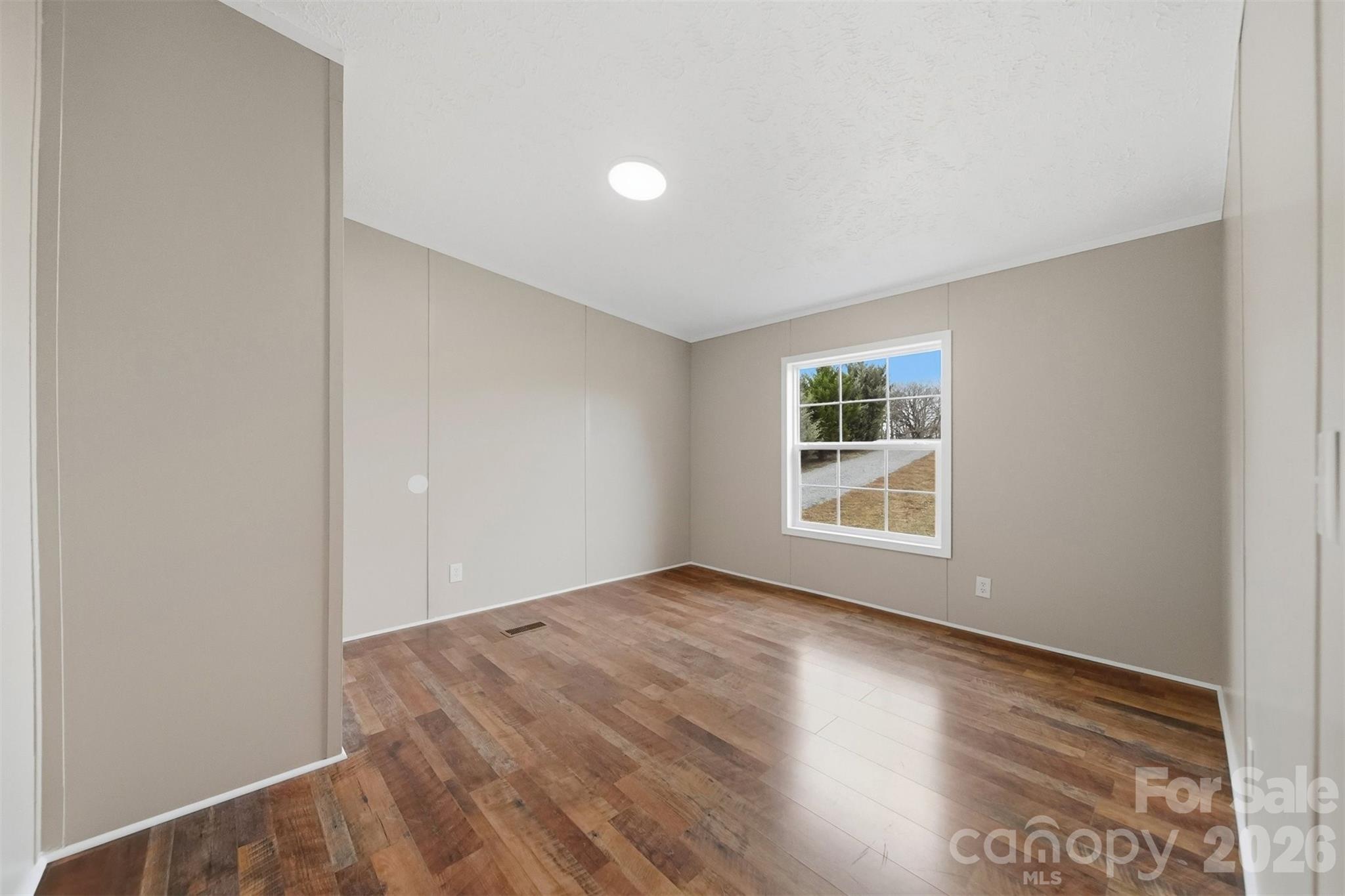 3150 Cranberry Road Boonville, NC 27011 - Photo 32 of 45 a view of an empty room with wooden floor and a window