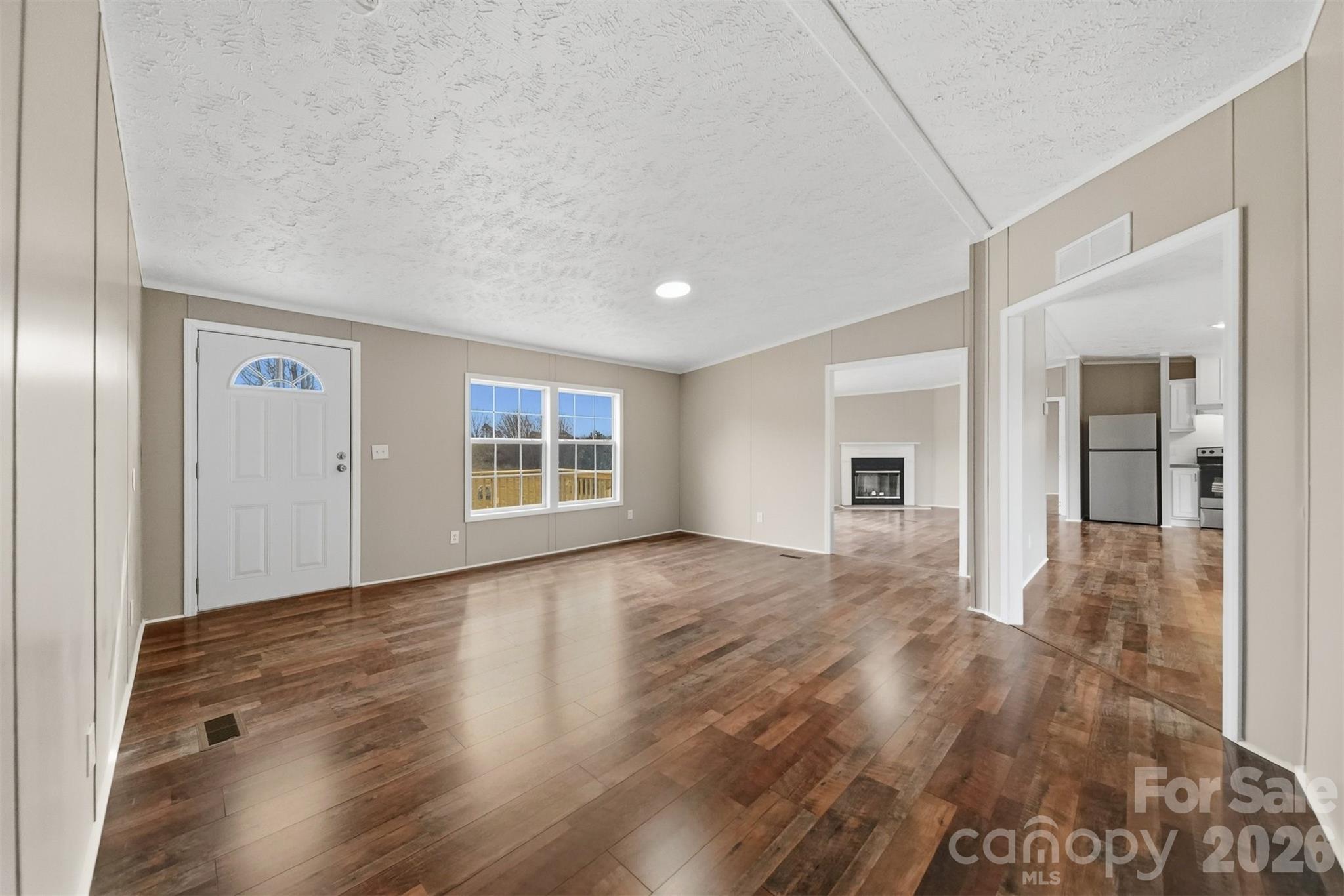 3150 Cranberry Road Boonville, NC 27011 - Photo 4 of 45 a view of empty room with wooden floor and windows