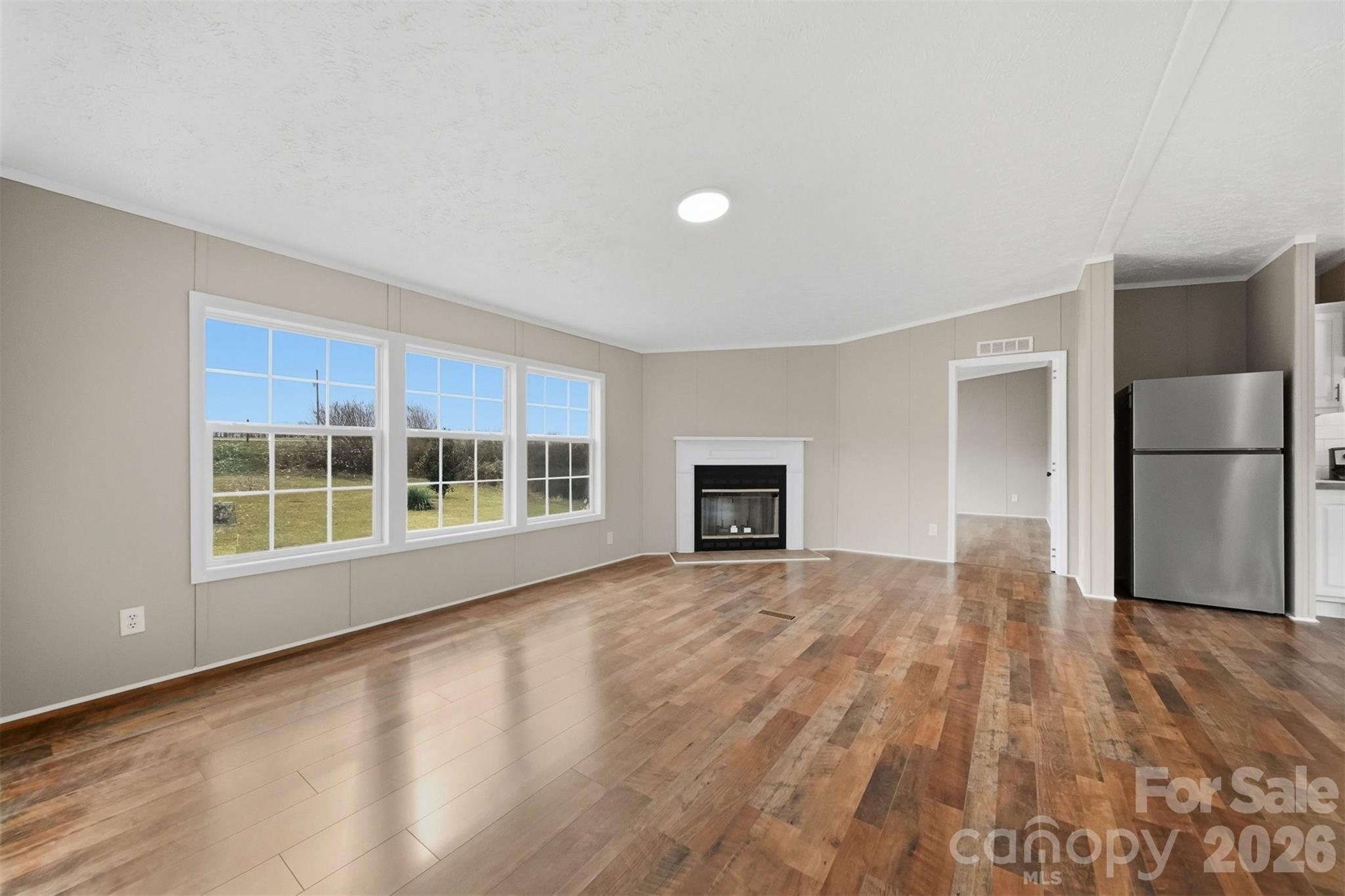 3150 Cranberry Road Boonville, NC 27011 - Photo 8 of 45 a view of an empty room with a window and wooden floor