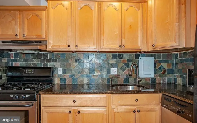 a kitchen with stainless steel appliances granite countertop a stove and a microwave