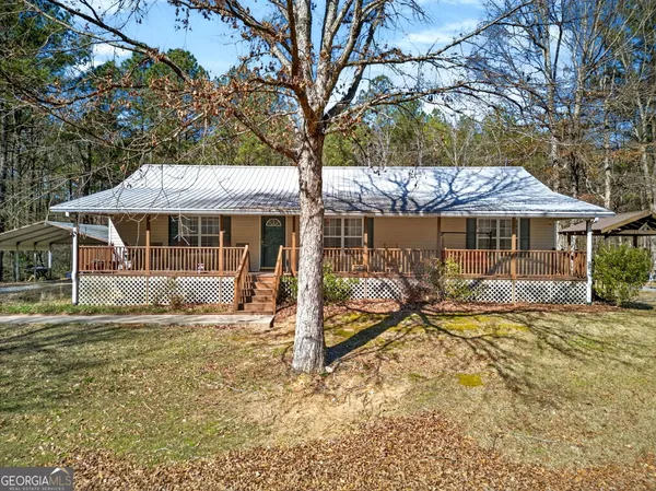 a view of a house with backyard porch and sitting area