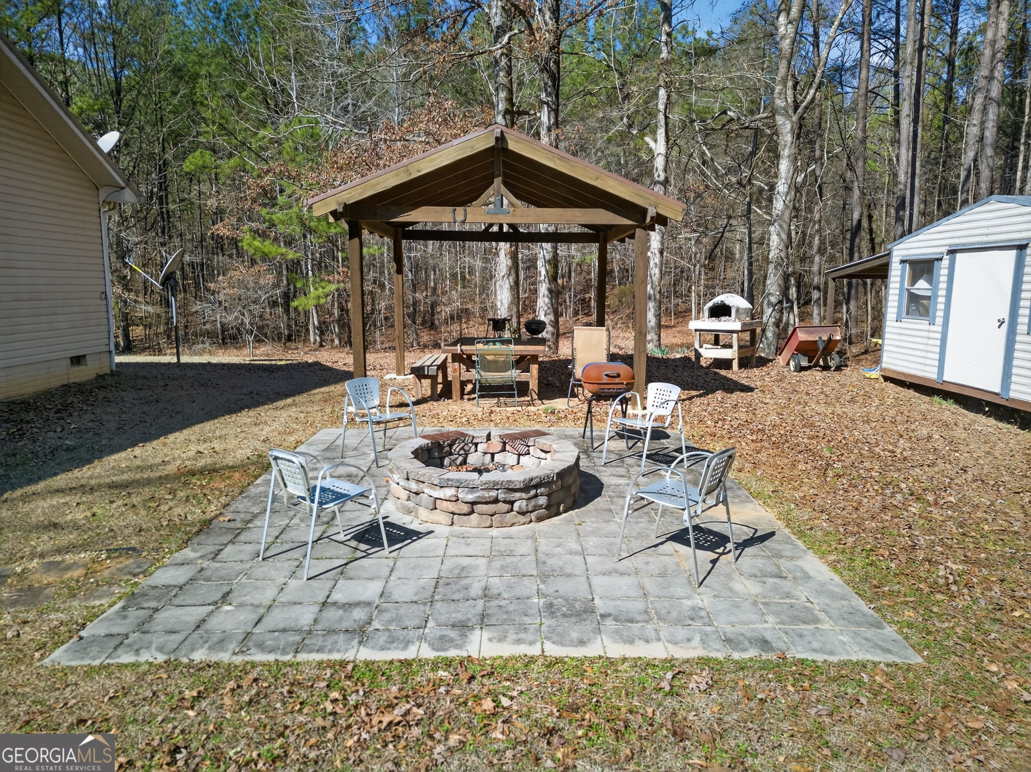 5010 Highway 27 Franklin, GA 30217 - Photo 19 of 39 a view of a patio with table and chairs with wooden floor and fence