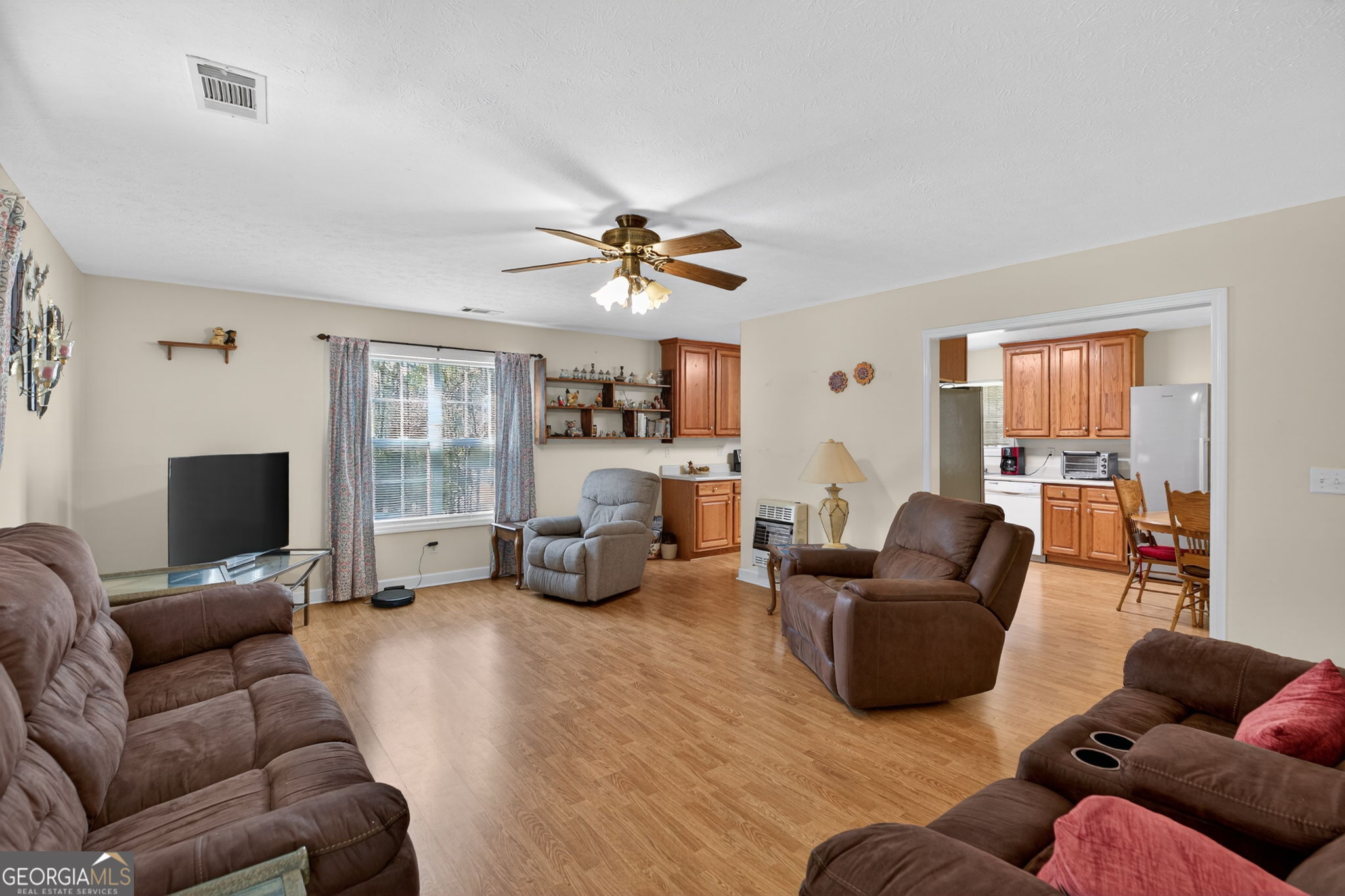 5010 Highway 27 Franklin, GA 30217 - Photo 6 of 39 a living room with furniture a fireplace and a flat screen tv