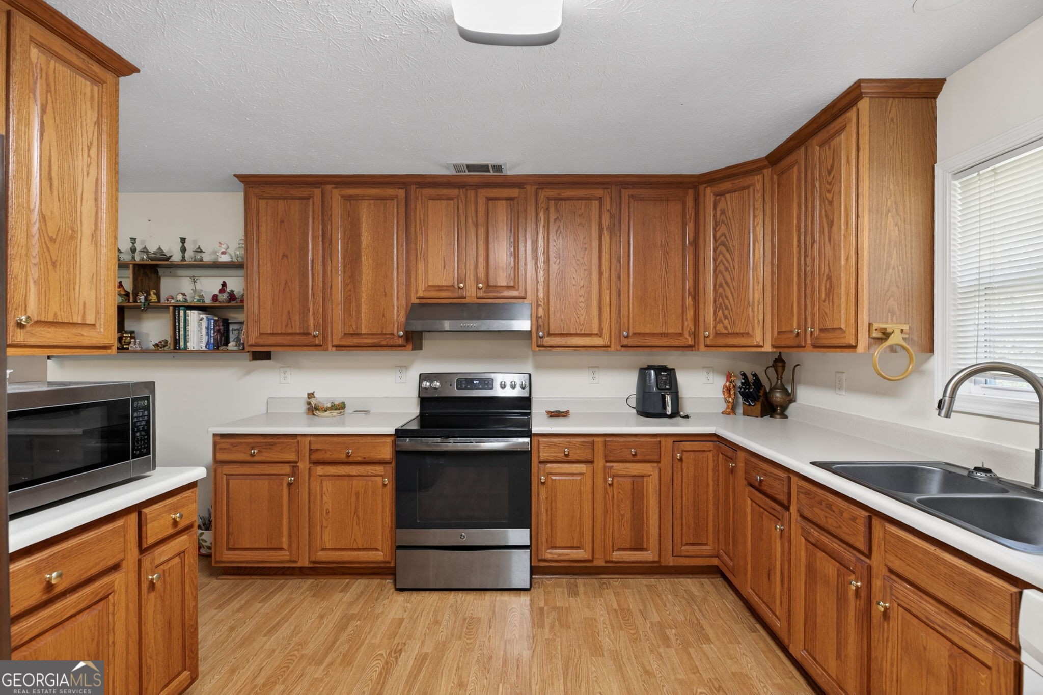 5010 Highway 27 Franklin, GA 30217 - Photo 8 of 39 a kitchen with stainless steel appliances granite countertop a sink a stove cabinets and wooden floor
