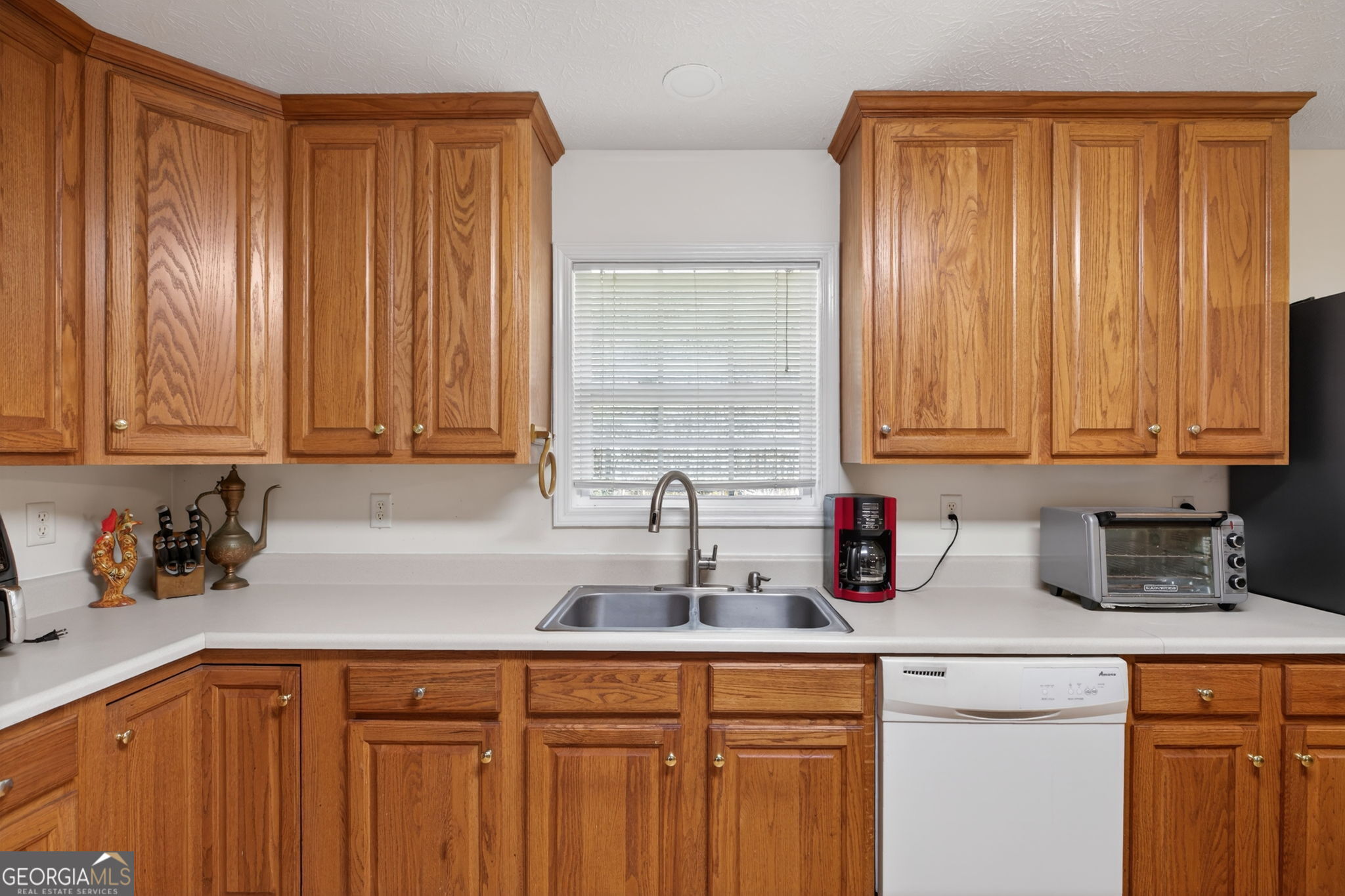 5010 Highway 27 Franklin, GA 30217 - Photo 9 of 39 a kitchen with stainless steel appliances sink refrigerator and cabinets