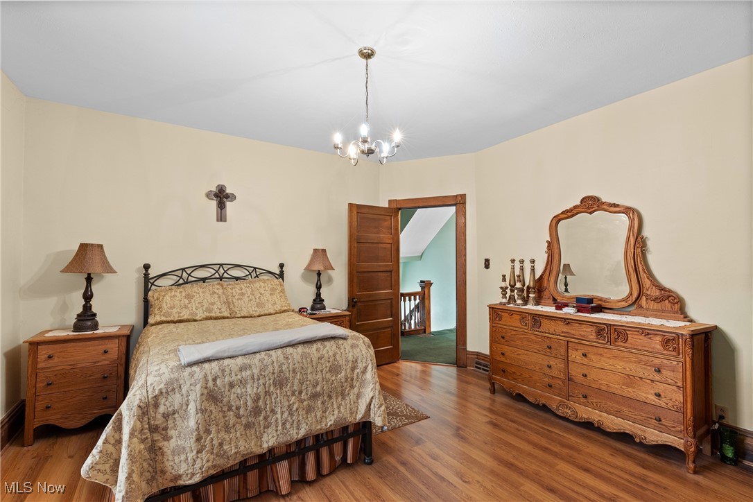 1011 Parriott Avenue Moundsville, WV 26041 - Photo 24 of 44 Bedroom featuring wood finished floors and a chandelier