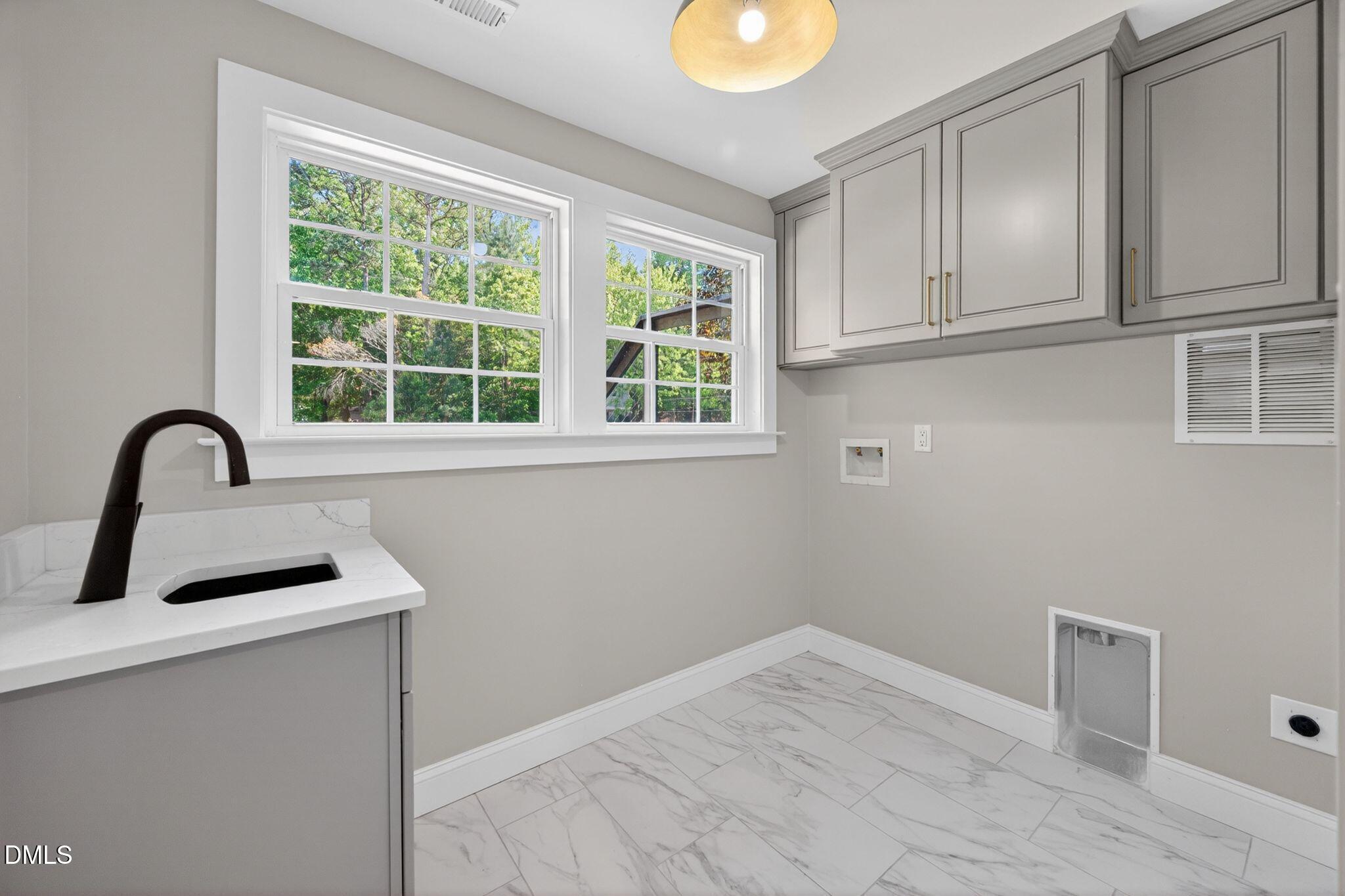 313 Crown Oaks Drive Raleigh, NC 27615 - Photo 33 of 60 a view of a kitchen with a sink and cabinets