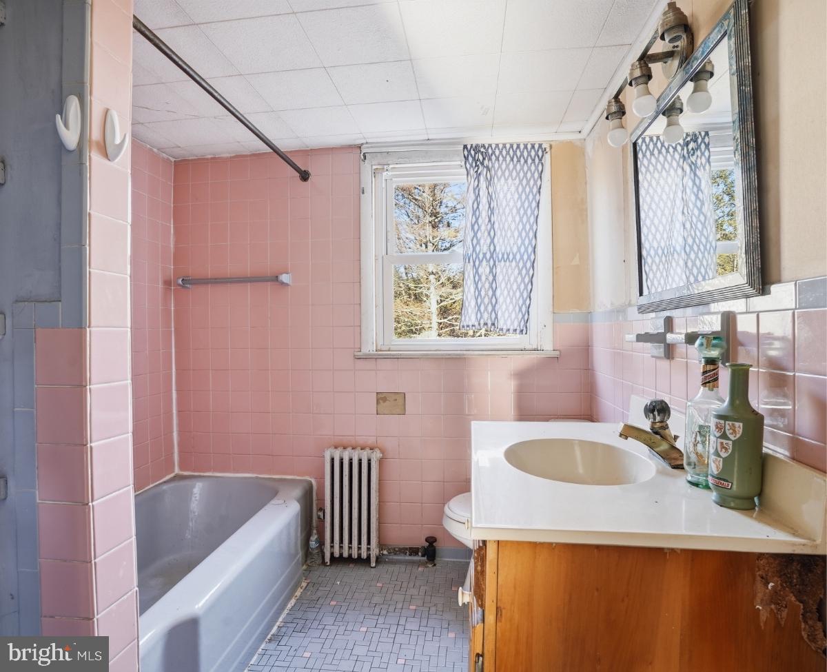 103 Ceramic Drive Newfoundland, PA 18445 - Photo 18 of 35 a bathroom with a sink a bathtub and a window