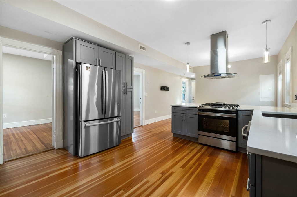 24 Howes Street, Unit 3 Boston, MA 02125 - Photo 1 of 15 a kitchen with granite countertop a refrigerator and a stove