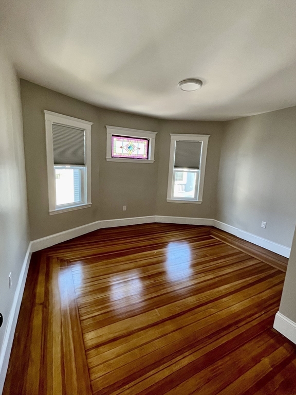 24 Howes Street, Unit 3 Boston, MA 02125 - Photo 11 of 15 a view of room with window and wooden floor