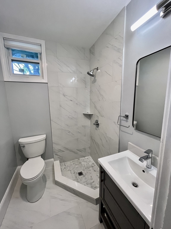 24 Howes Street, Unit 3 Boston, MA 02125 - Photo 13 of 15 a bathroom with a sink a toilet and shower